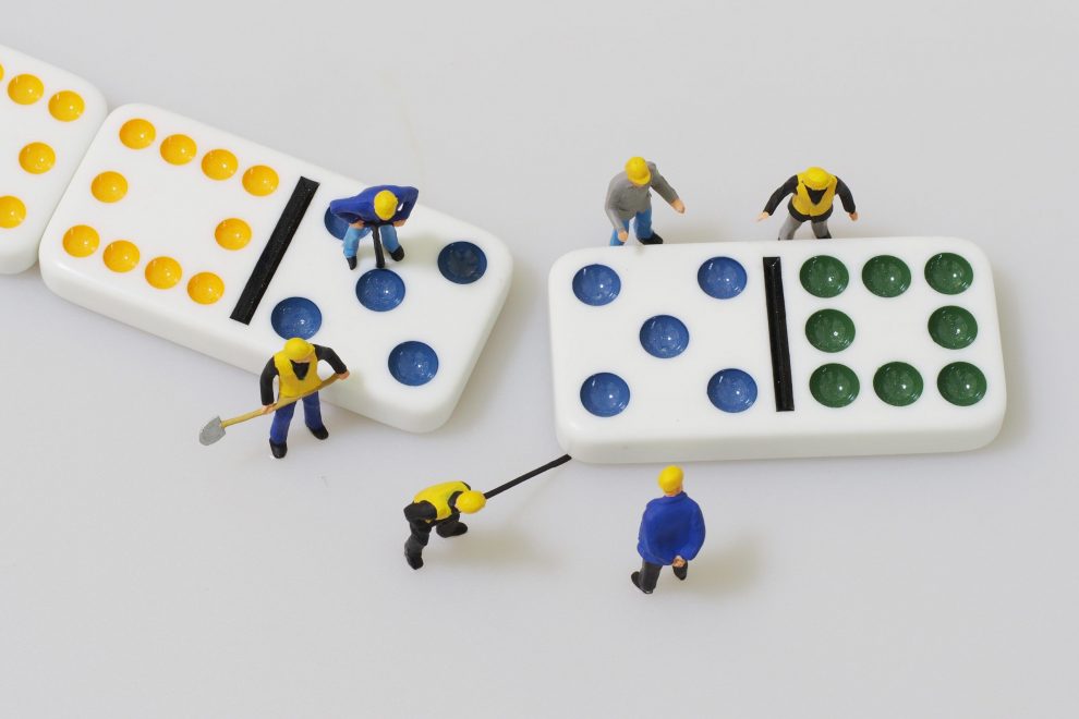 Group of engineer workers are making dominos