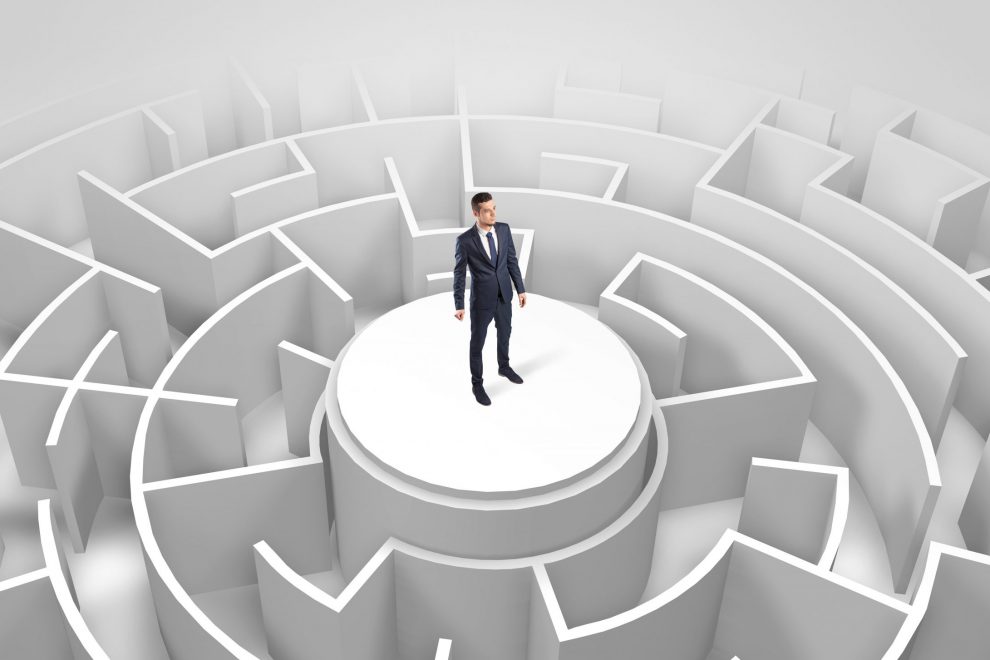 Businessman standing on the top of a maze
