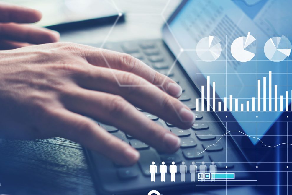 Concept of virtual diagram,graph interfaces,digital display,connections,statistics icons.Man using contemporary electronic tablet with dock keyboard.Blurred background. Vertical.