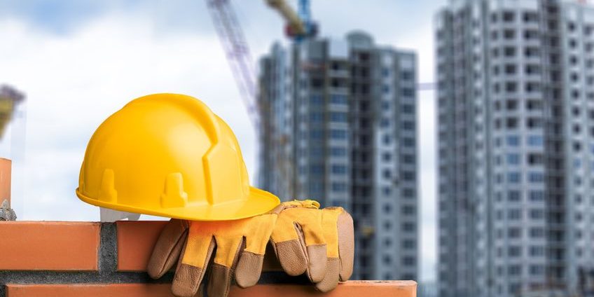 Yellow helmets on brickwork