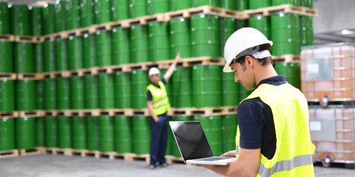 Worker,In,A,Warehouse,With,Oil,Barrels,Checks,The,Stock
