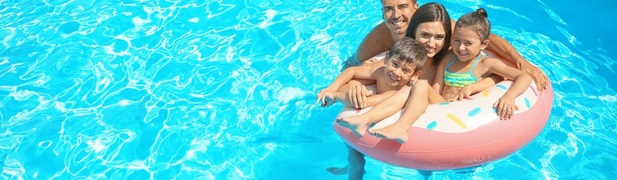 Happy,Family,With,Inflatable,Ring,Relaxing,In,Swimming,Pool